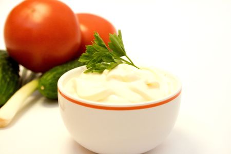 mayonnaise with tomatos, leeks and cucumbers over white backgroundの写真素材