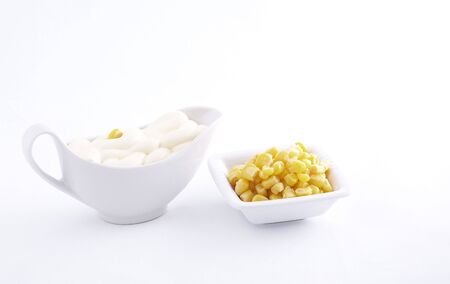 maize in plate and mayonnaise in white sauce-boat  の写真素材