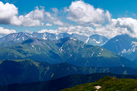 View of high mountain ranges to the horizon from one of the peaks