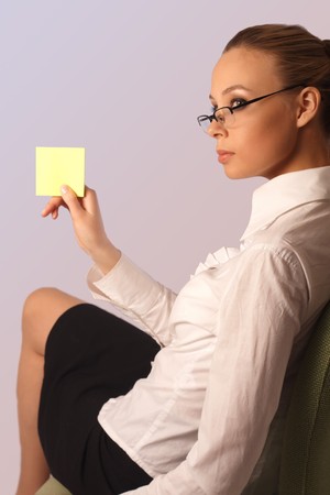 girl on a chair holds an empty stickerの写真素材