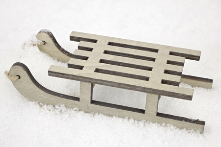 A small wooden sled in closeup as a decorative backgroundの写真素材