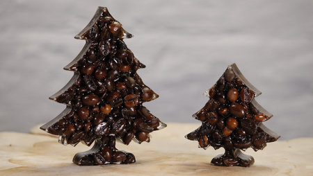 Two Christmas trees of different sizes made from roasted coffee beans on a light background. Creative holiday food concept symbolizing warmth, aroma, and festive cafÃ© cultureの写真素材