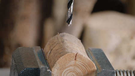 Macro shot of a wood drill cutting into wood as part of a DIY woodworking project.の写真素材