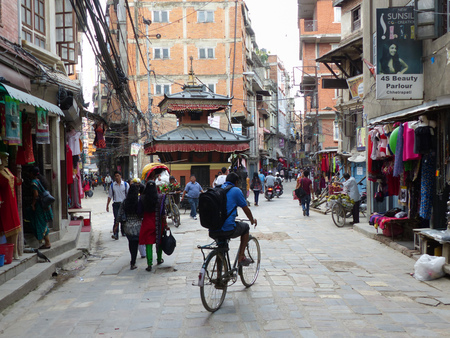 Kathmandu, Nepal, september 4, 2015: People are walking on cobbled road in Thamel - Kathmandu