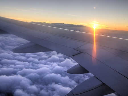 Flying above the clouds, Sunrise over the planes wingの写真素材