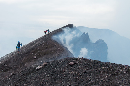 To the top of the Etna volcano, Hikers go on the lava fields to the summit of Etnaの写真素材