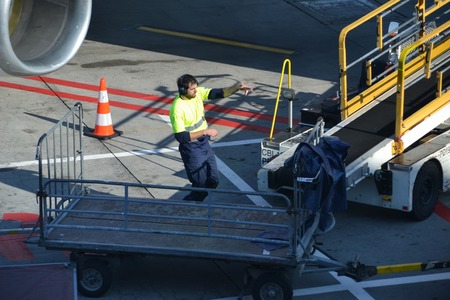 Prague Airport Czech Republic, october 10, 2018 Men loading Pegasus airlines aircraft in Vaclav Havel Prague Airportのeditorial素材