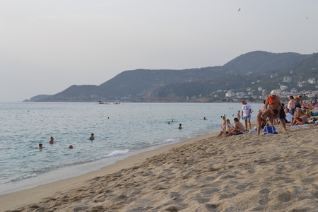 Alanya Turkey october 16, 2018: Cold evening on Cleopatra beach in Alanya, Turkey, people on the beach and in water doing leisure activityのeditorial素材