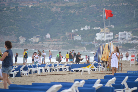 Alanya Turkey october 25, 2018: Cloudy day on Cleopatra beach in Alanya, Turkey, people on the beach watching and taking photos of stormy waves on the seaのeditorial素材