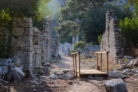 Peaceful Walk Through Ancient Stone Ruins of Olympos Turkey with Lush Greenery and Mountain Viewsの写真素材