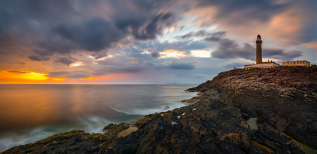Lighthouse on cliffs of Ardnamurchan Point in colorful sunset, Highlands, Scotlandの写真素材