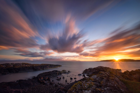 Ardneil Bay with distant Isle of Arran in colorful sunset, Highlands, Scotlandの写真素材
