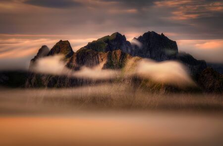 Mountains covered by clouds on Moskenesoya sunset, Lofoten