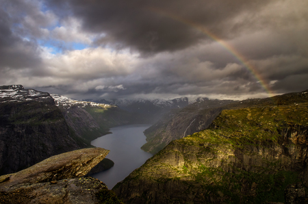 Rainbow over Trolltunga in cloudy weather, Norwayの写真素材
