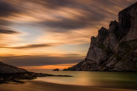 Sunset on Bunes beach with rocky mountains in background, Lofotenの写真素材