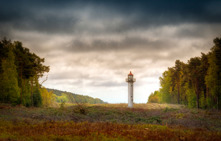 Old lighthouse among trees on Wolin island, Polandの写真素材