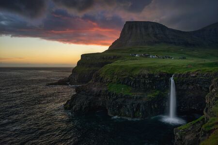 Gasadalur village and Mulafossur waterfall in sunset, Faroe Islandsの写真素材