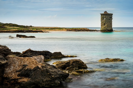 Genovese tower Santa Maria at Cap Corse with rocks on foreground, France, Corsicaの写真素材