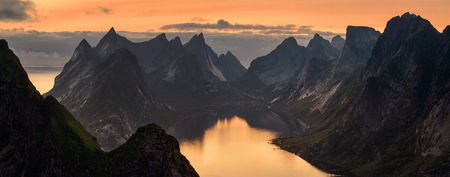 Panorama of Kjerkfjorden among dramatic mountain ridges in sunset light, Lofoten