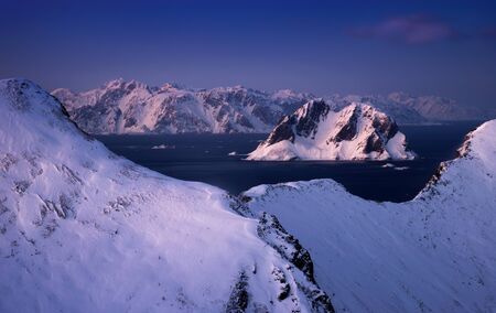 Wiinter Mosken island with main Lofoten in background at sunset, Norwayの写真素材