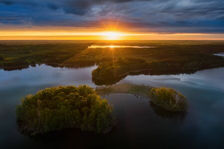 Two islands on Gromskie Lake in Mazuras in sunset light, Polandの写真素材