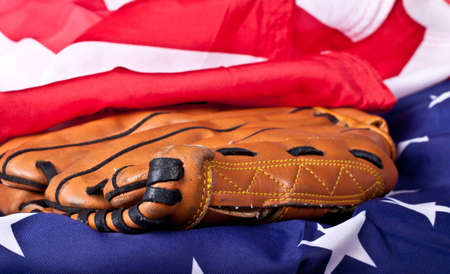 An abstract photograph of a baseball glove and an American flag.の写真素材