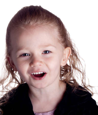 A girl looks at the viewer with excitement.  She looks like she is talking or agreeing with the...
