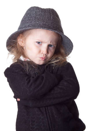 An isolation of a child on white.  Her lips are pursed and she is very serious.  Way too cool.