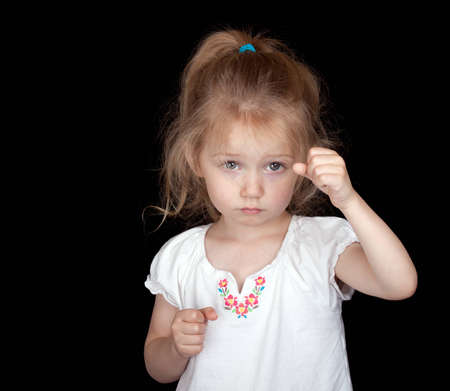 A photograph of a cute but sad child that could be holding something.の写真素材
