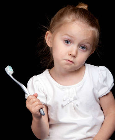 A very cute girl takes care of her teeth very well.