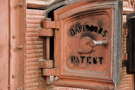 Detail of old doors of furnace for heating in tea factoryの写真素材