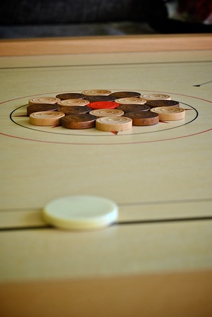 Carrom striker with black and white coinsの写真素材