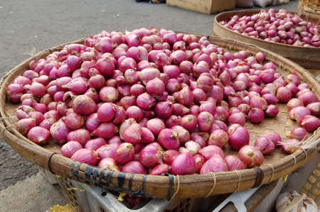 Kebalen Market, Malang, Indonesia- July 1, 2021 : lot's of garlic in a basketの写真素材