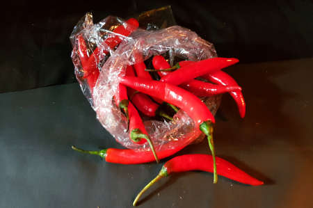 lot's of red hot chillies in plastic bagの写真素材