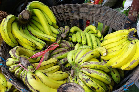Malang, Indonesia - July 1, 2021 : a pile of bananas in a bamboo basketの写真素材