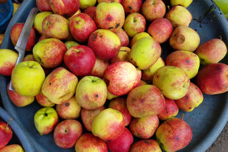 Malang, Indonesia - July 1, 2021 :
lots of local apples on a plastic basketの写真素材