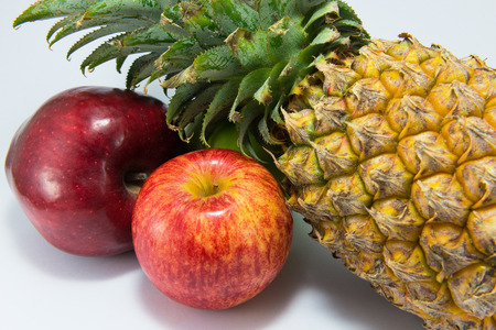 Two apples and pineapple isolated on white background.の写真素材