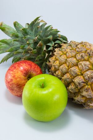 Two apples and pineapple isolated on white background.の写真素材