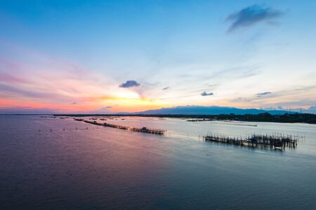 Thai's traditional fish baskets and morning landscape view from the bridge Taksin Maharat Bridge in Chonburi province, Thailand.の写真素材