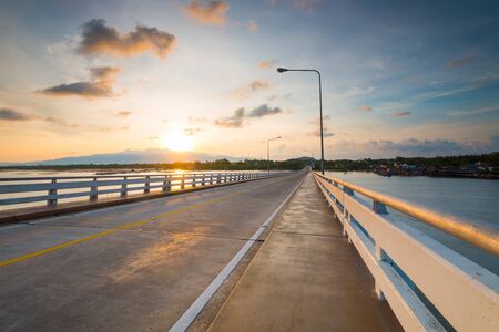looking sunrise on the bridge Taksin Maharat Bridge walkway in Chonburi province, Thailand.の写真素材