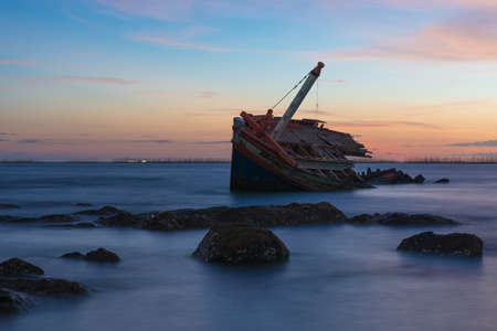 Abandoned ship with sunsetの写真素材