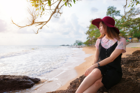 Young Asia woman closed to a beach, Portrait and beach travel conceptの写真素材