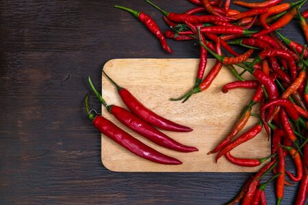 Chilli on wooden background, overhead view. low key tone.の写真素材