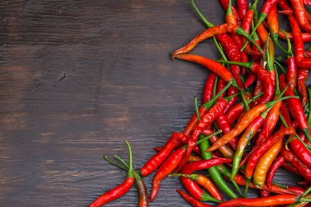 Chili on wooden background, overhead view. low key tone.の写真素材