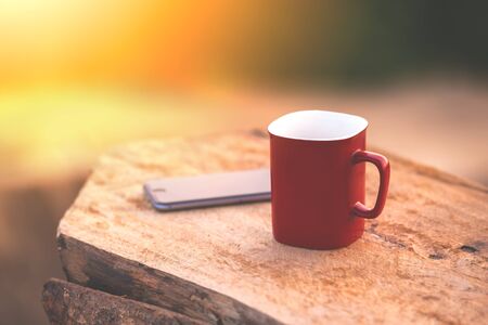 Cup of coffee on a wooden table in morning. vintage picture style processed.の写真素材