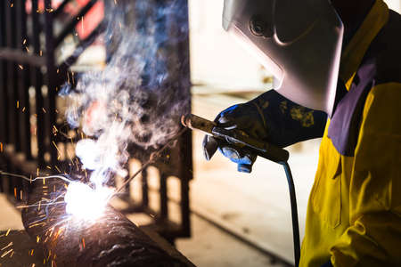 Electric wheel grinding on steel structure in factoryの写真素材