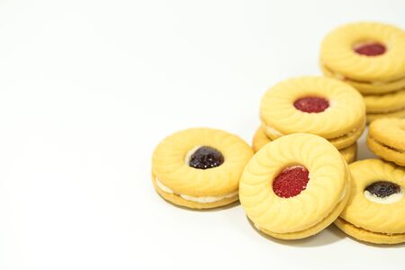 Butter cookies with strawberry jam filling on the top isolated on white backgroundの写真素材