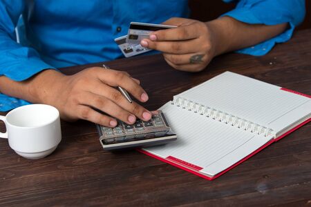 Man analyzing credit card paymentの写真素材