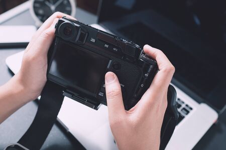 Digital Photography Workstation. Modern Digital DSLR Camera, Laptop Computer and Display.の写真素材