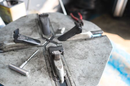 Mechanic removes car tire closeup. Machine for removing rubber from the wheel discの写真素材